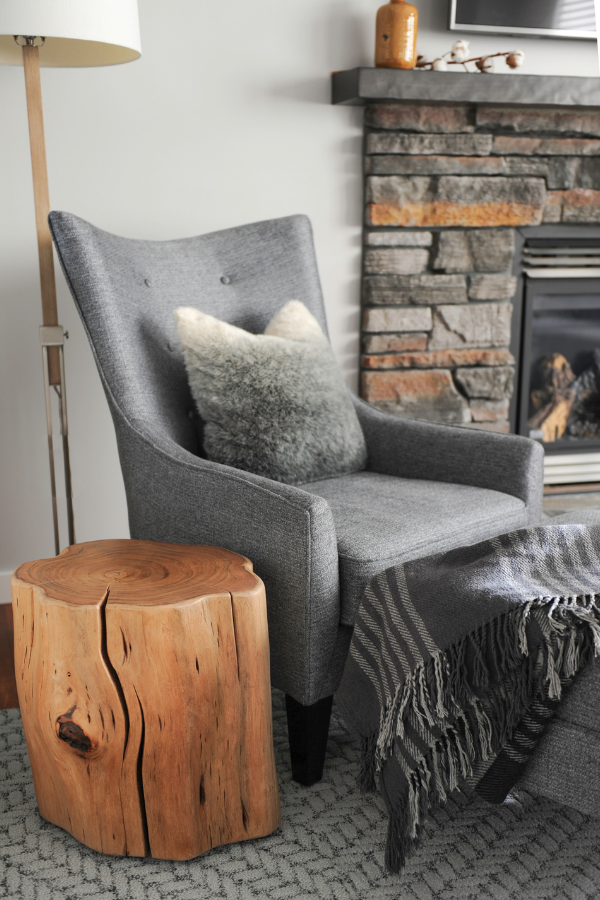 Simply-Home-Decorating_Lori-Steeves_Vancouver-BC_Canadian-Designer_How-to-Avoid-5-Huge-Home-Furnishing-Mistakes_Gray-Accent-Chair-with-Wood-Side-Table-by-Fireplace