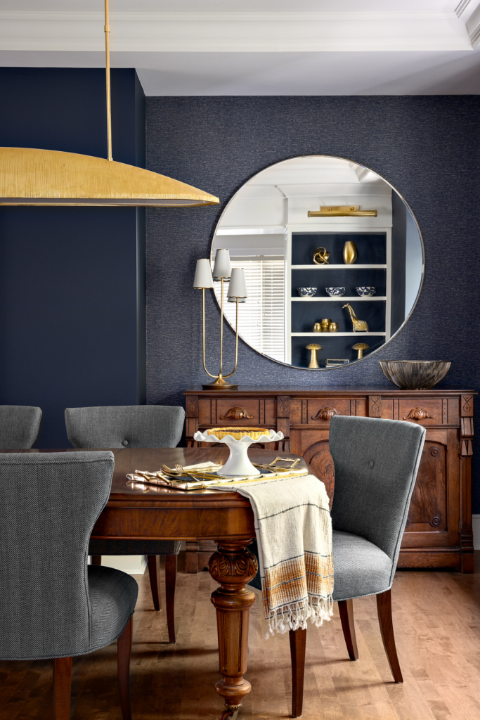 full-service-interior-designer-west-vancouver-ca-incorporating-antiques-into-your-modern-home-vintage-dining-table-in-moody-dark-blue-dining-room-brass-accents-everyday-luxury-design