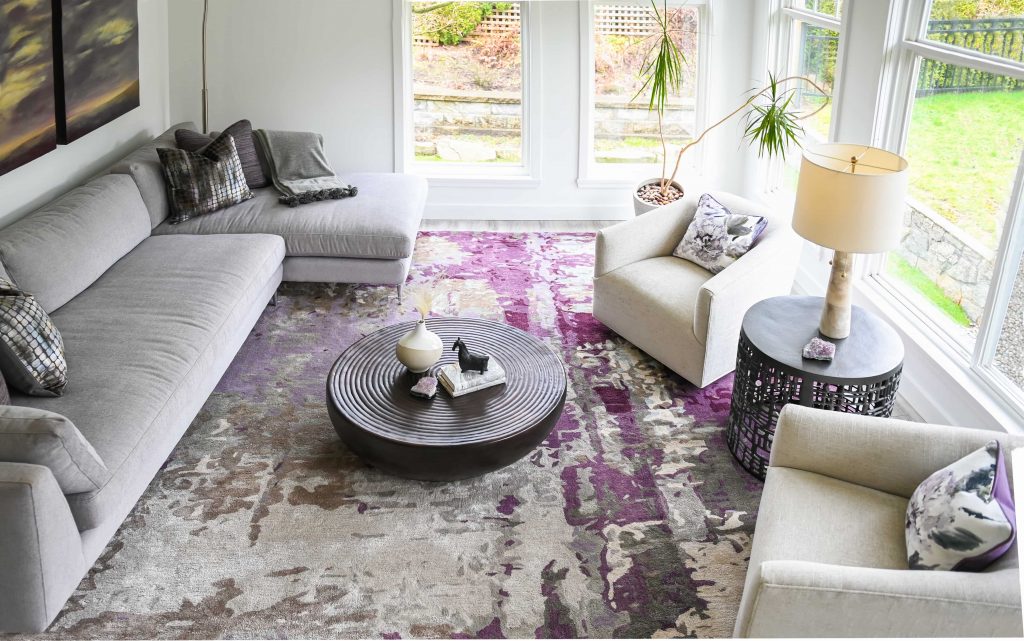 simply-home-decorating-edgemont-ca-statement-pieces-interior-design-statement-rug-neutral-sofas-large-windows-contemporary-design
