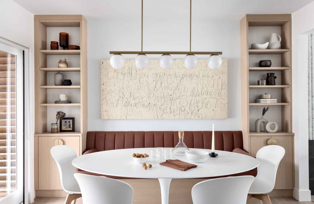 full-service-interior-design-edgemont-bc-finishing-touches-in-interior-design-built-in-banquette-dining-area-custom-shelves-unique-art-refined-home-furnishings