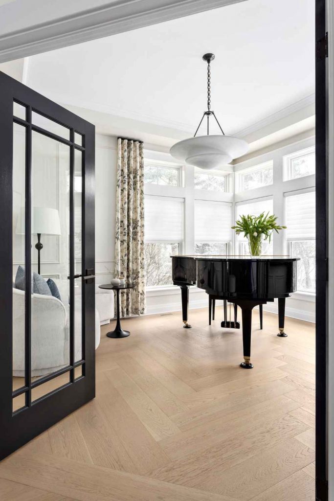 full-service-interior-design-edgemont-bc-interior-design-investment-black-french-doors-open-to-music-room-with-grand-piano-wood-floors-elevated-design