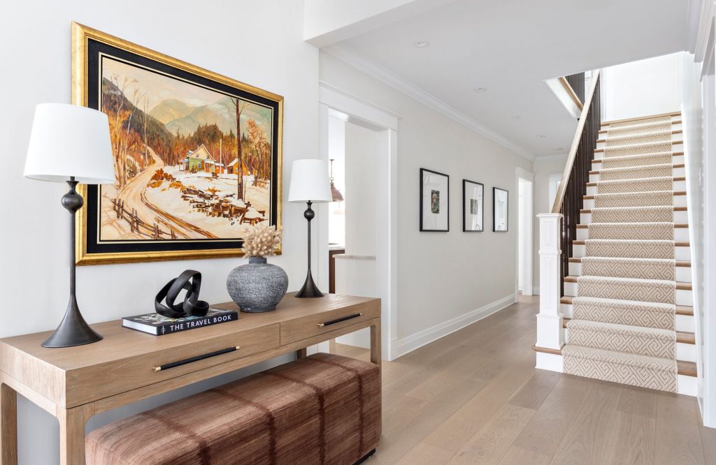 full-service-interior-design-lions-bay-home-furnishing-plan-home-entryway-custom-console-table-with-lamps-and-art-hallway-and-stairs-light-wood-floor-refined