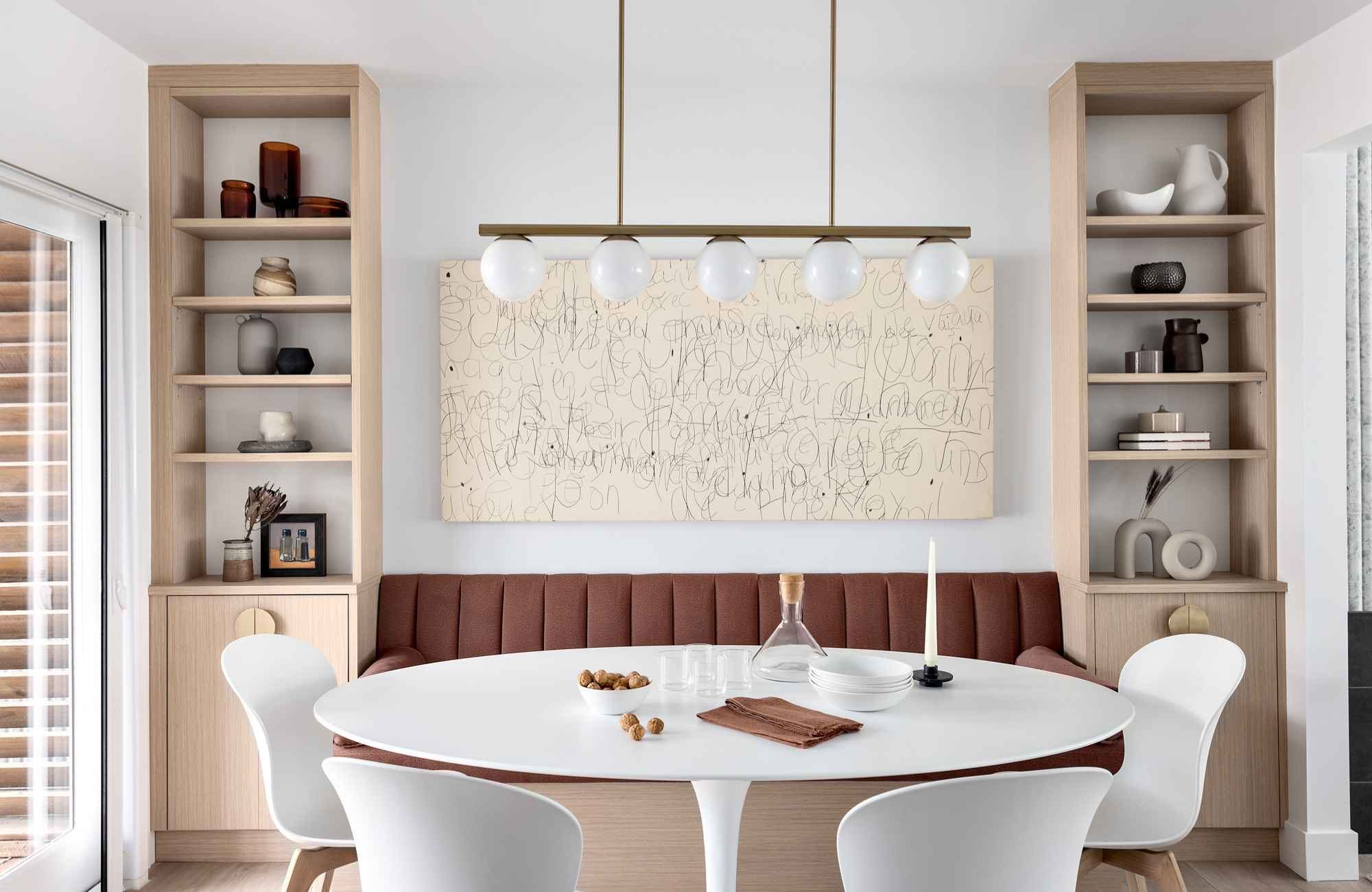 full-service-interior-design-edgemont-bc-finishing-touches-in-interior-design-built-in-banquette-dining-area-custom-shelves-unique-art-refined-home-furnishings